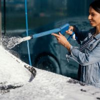 woman-washing-her-car-outdoors_23-2148958770