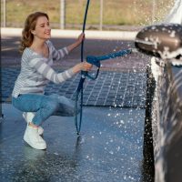 woman-washing-her-car-outdoors_23-2148958773